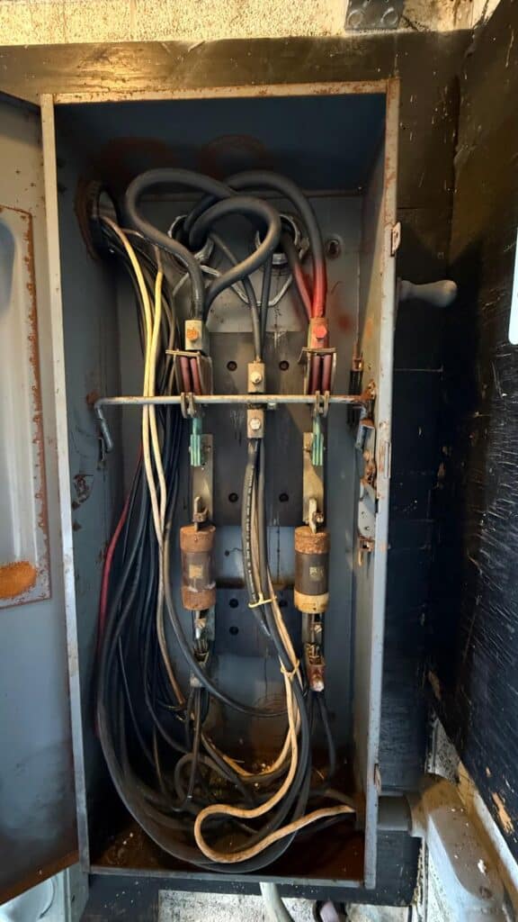 Corroded obsolete fused disconnect flagged during building recertification